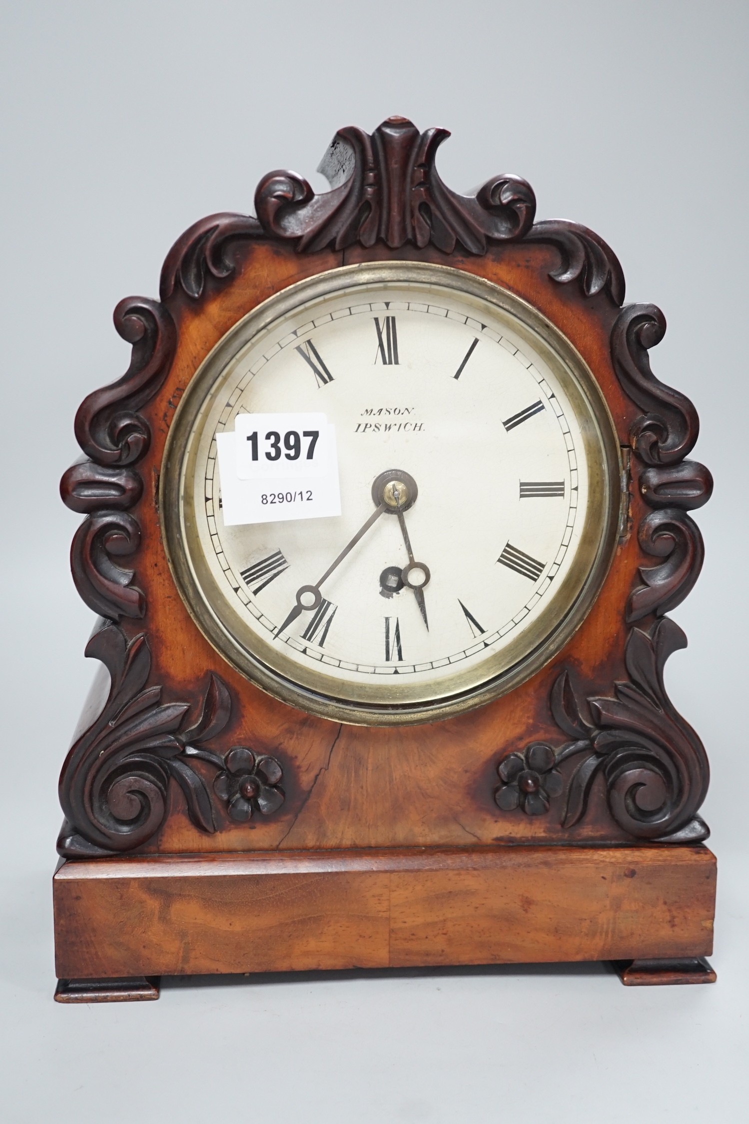 Mason, Ipswich. A 19th century mahogany cased mantel clock with scrolling moulded decoration - 31cm tall
